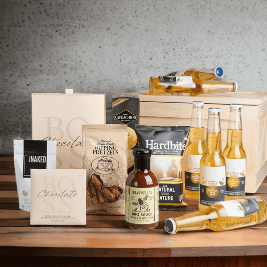 Included in this gift basket are all natural chips, crackers, honey habanero BBQ sauce, honey wheat pretzels, a milk chocolate bar, assorted chocolate truffles, pistachios, and 6 bottles of Corona beer, all packed into a wooden gift crate.
