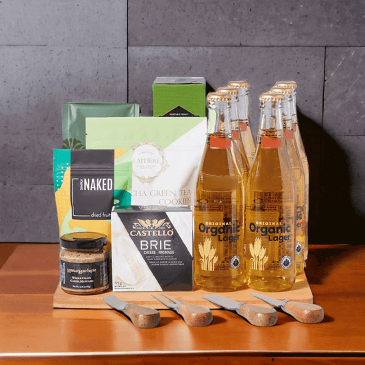 Gourmet Beer Gift Board which includes six beers, matcha green tea cookies, crackers, coffee beans, dried mango, whole grain garlic mustard, and creamy brie cheese.
