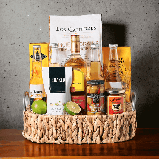 This gift is made for celebrations! It includes a bottle of liquor, four beers, roasted garlic salsa, tipsy fiery olives, limes, crackers, tortilla chips, waffle pretzels, dry roasted pistachios, and a woven serving tray.